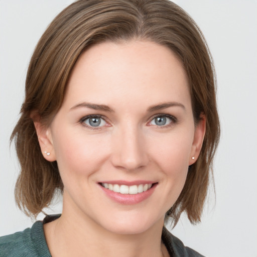 Joyful white young-adult female with medium  brown hair and blue eyes