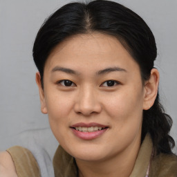 Joyful asian young-adult female with medium  brown hair and brown eyes