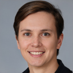 Joyful white adult female with short  brown hair and grey eyes