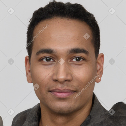 Joyful black young-adult male with short  black hair and brown eyes