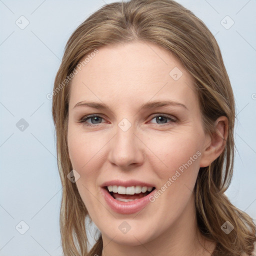 Joyful white young-adult female with long  brown hair and grey eyes