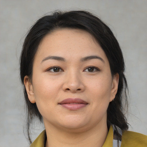 Joyful asian young-adult female with medium  brown hair and brown eyes