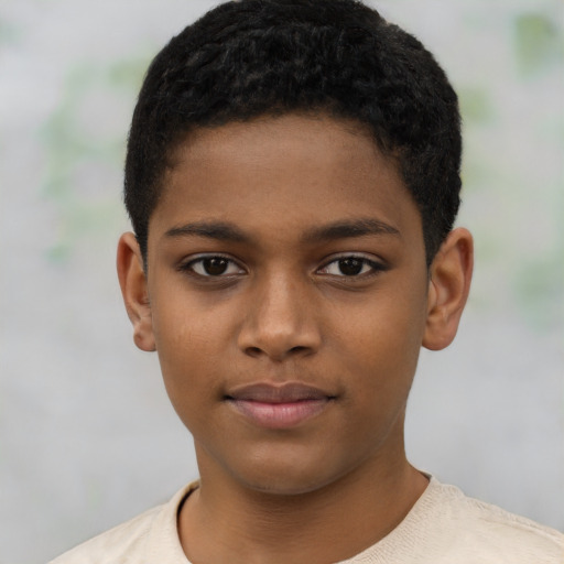 Joyful black child male with short  brown hair and brown eyes