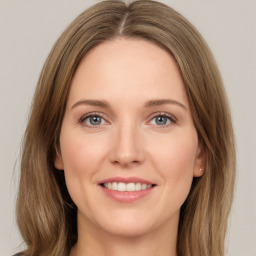 Joyful white young-adult female with medium  brown hair and green eyes