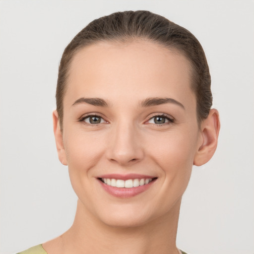 Joyful white young-adult female with short  brown hair and grey eyes