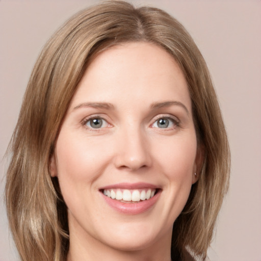 Joyful white young-adult female with medium  brown hair and green eyes