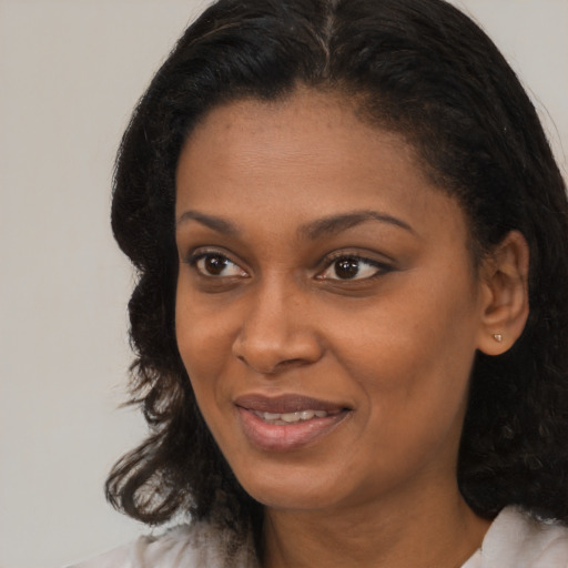 Joyful black young-adult female with medium  black hair and brown eyes