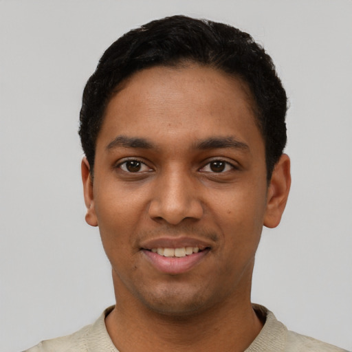 Joyful black young-adult male with short  black hair and brown eyes