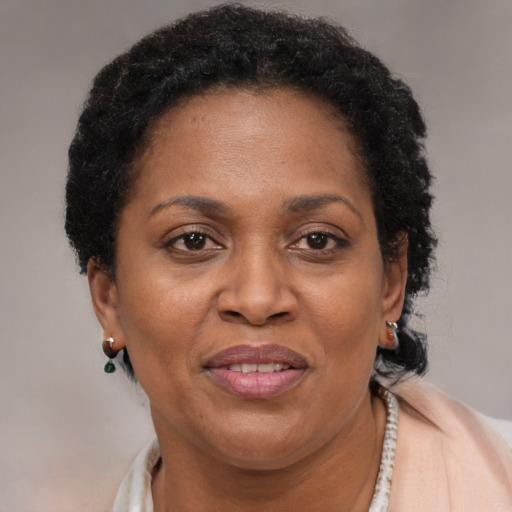 Joyful black adult female with short  brown hair and brown eyes