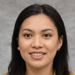 Joyful asian young-adult female with long  brown hair and brown eyes