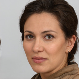 Joyful white adult female with medium  brown hair and brown eyes