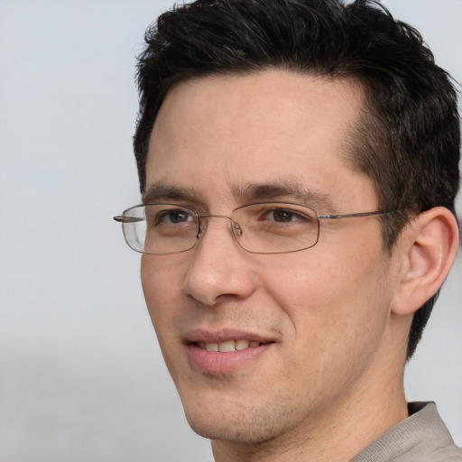 Joyful white adult male with short  brown hair and brown eyes