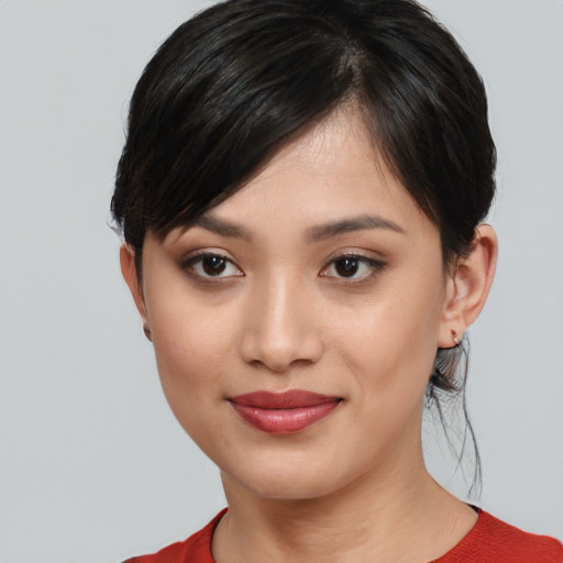 Joyful white young-adult female with medium  black hair and brown eyes