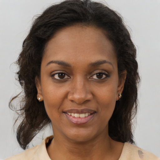 Joyful black young-adult female with medium  brown hair and brown eyes