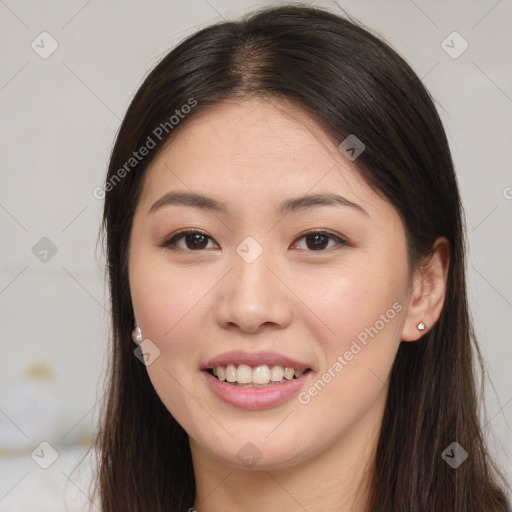 Joyful asian young-adult female with long  brown hair and brown eyes