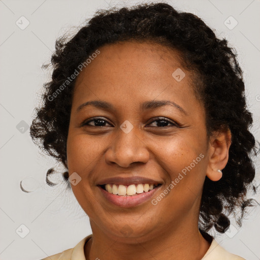 Joyful black adult female with medium  brown hair and brown eyes