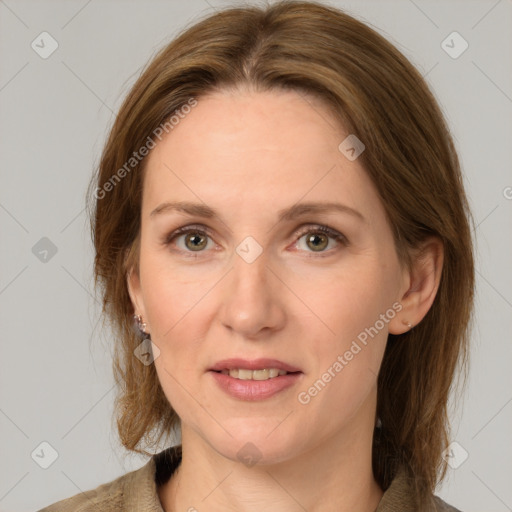 Joyful white adult female with medium  brown hair and grey eyes