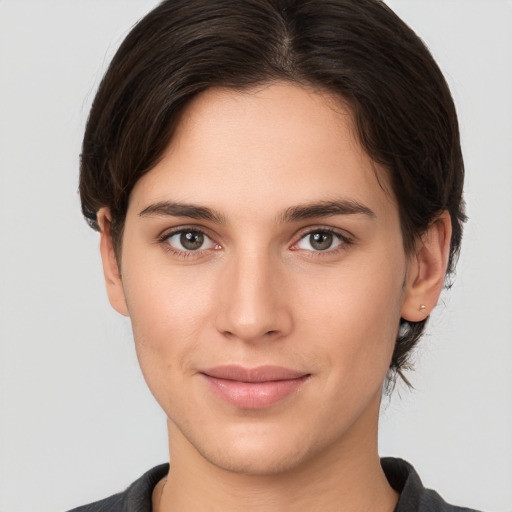 Joyful white young-adult female with short  brown hair and brown eyes