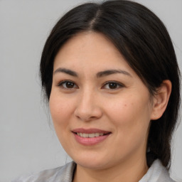 Joyful asian young-adult female with medium  brown hair and brown eyes