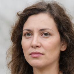 Joyful white adult female with long  brown hair and brown eyes