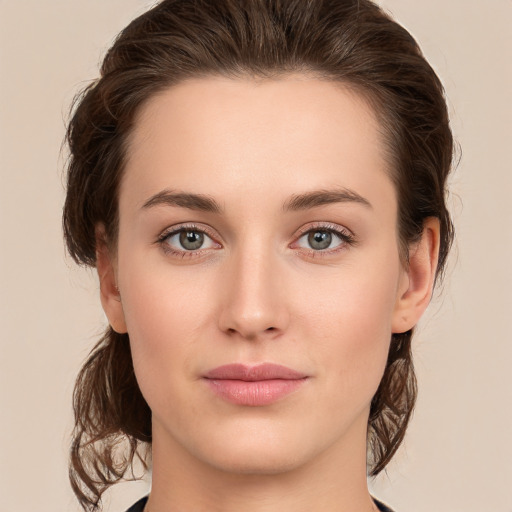 Joyful white young-adult female with medium  brown hair and green eyes