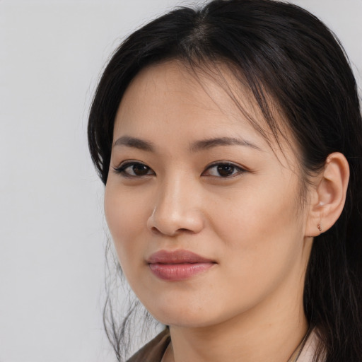 Joyful asian young-adult female with long  brown hair and brown eyes