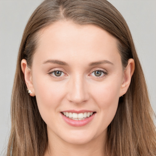 Joyful white young-adult female with long  brown hair and grey eyes