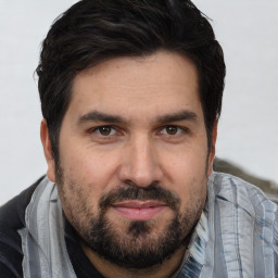 Joyful white adult male with short  brown hair and brown eyes