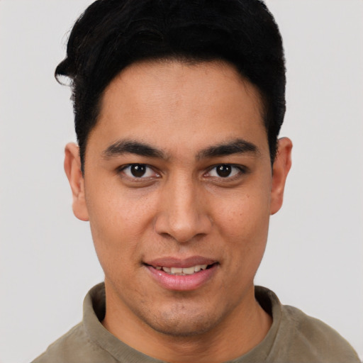 Joyful latino young-adult male with short  black hair and brown eyes