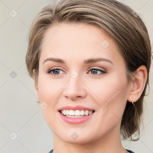 Joyful white young-adult female with medium  brown hair and green eyes