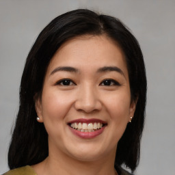 Joyful asian young-adult female with medium  brown hair and brown eyes