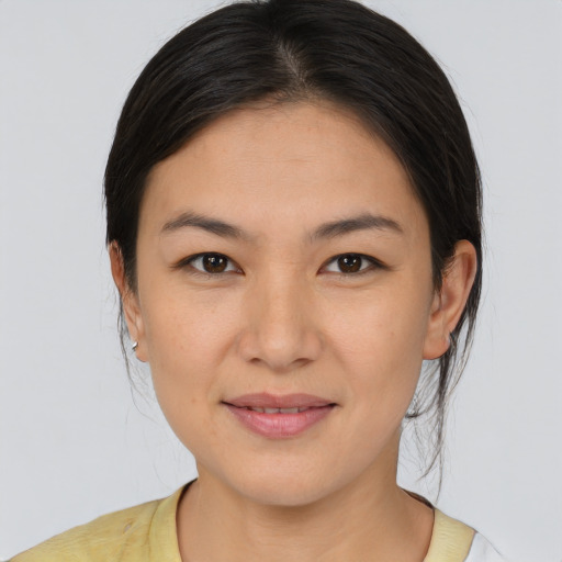 Joyful white young-adult female with medium  brown hair and brown eyes