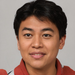 Joyful asian young-adult male with short  brown hair and brown eyes