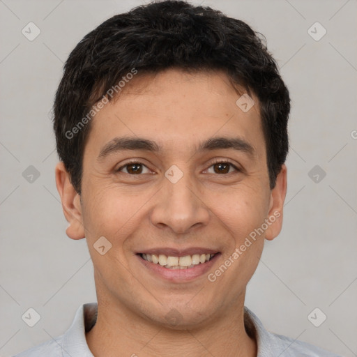 Joyful white young-adult male with short  black hair and brown eyes