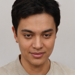 Joyful latino young-adult male with short  brown hair and brown eyes