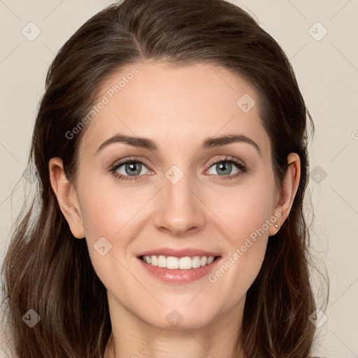 Joyful white young-adult female with long  brown hair and blue eyes