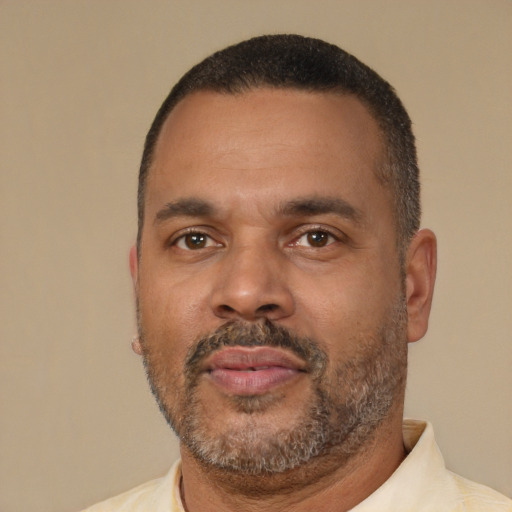 Neutral latino adult male with short  black hair and brown eyes