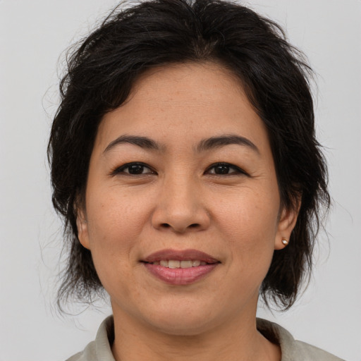 Joyful asian adult female with medium  brown hair and brown eyes