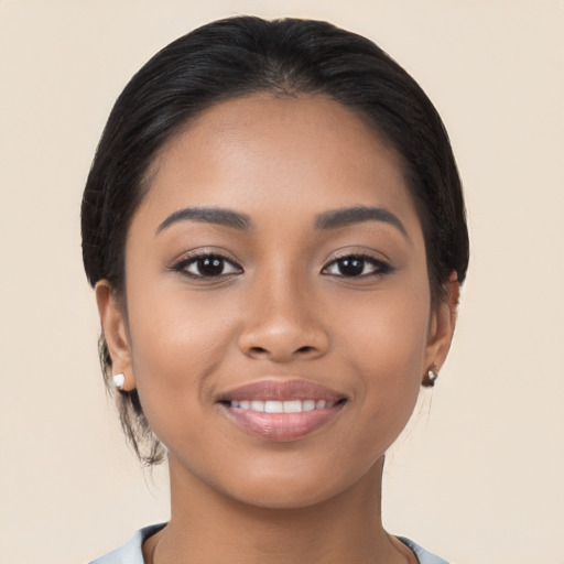 Joyful latino young-adult female with medium  black hair and brown eyes