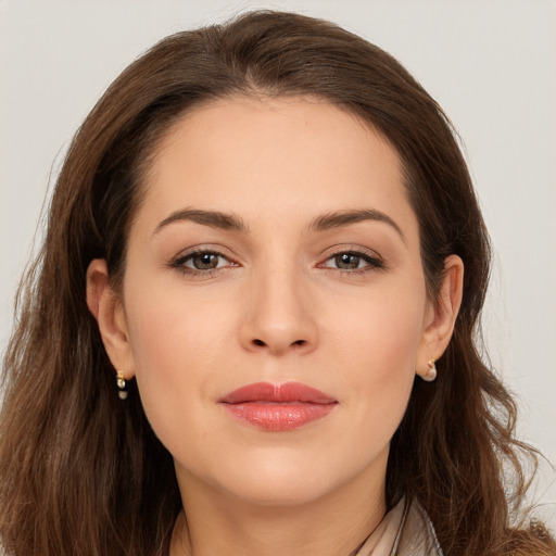 Joyful white young-adult female with long  brown hair and brown eyes