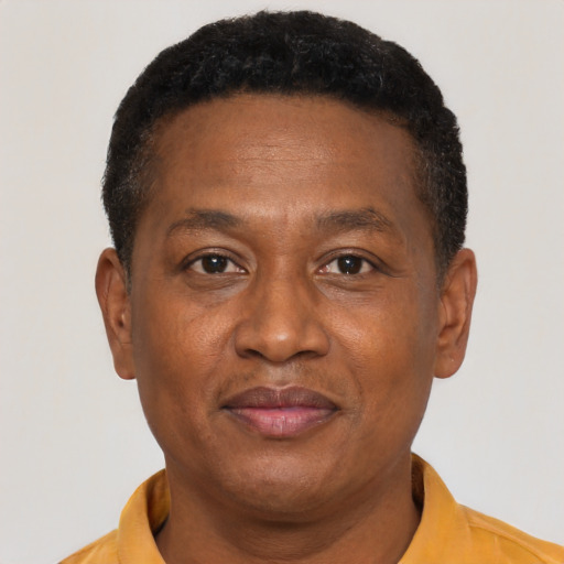 Joyful black adult male with short  brown hair and brown eyes