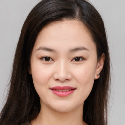 Joyful asian young-adult female with medium  brown hair and brown eyes