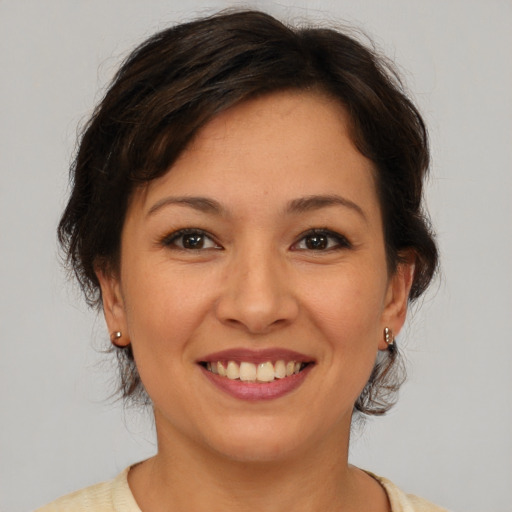 Joyful asian young-adult female with medium  brown hair and brown eyes