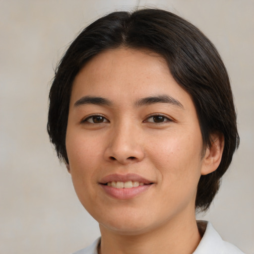 Joyful asian young-adult female with medium  brown hair and brown eyes