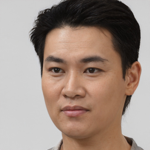 Joyful asian young-adult male with short  black hair and brown eyes