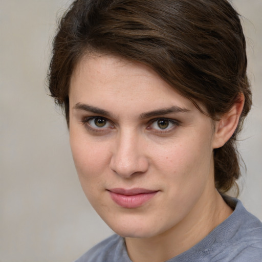 Joyful white young-adult female with medium  brown hair and grey eyes