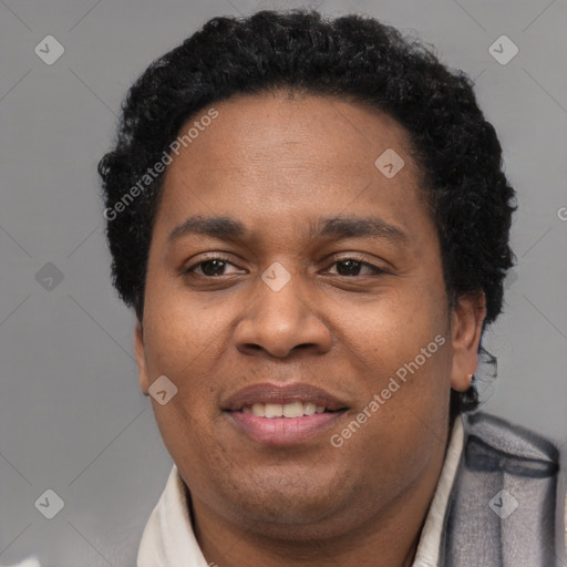 Joyful black young-adult male with short  brown hair and brown eyes