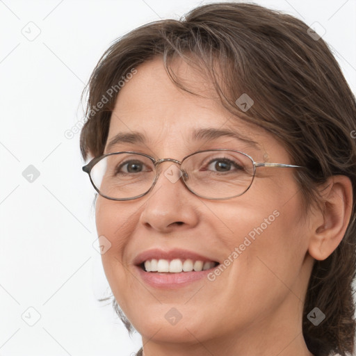 Joyful white adult female with medium  brown hair and grey eyes