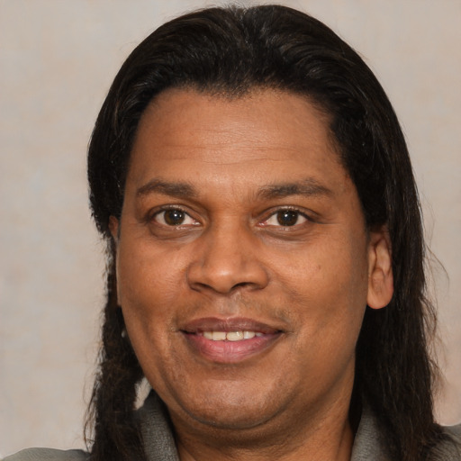 Joyful latino adult male with medium  brown hair and brown eyes