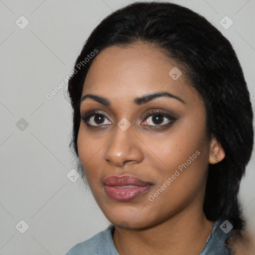 Joyful black young-adult female with long  black hair and brown eyes